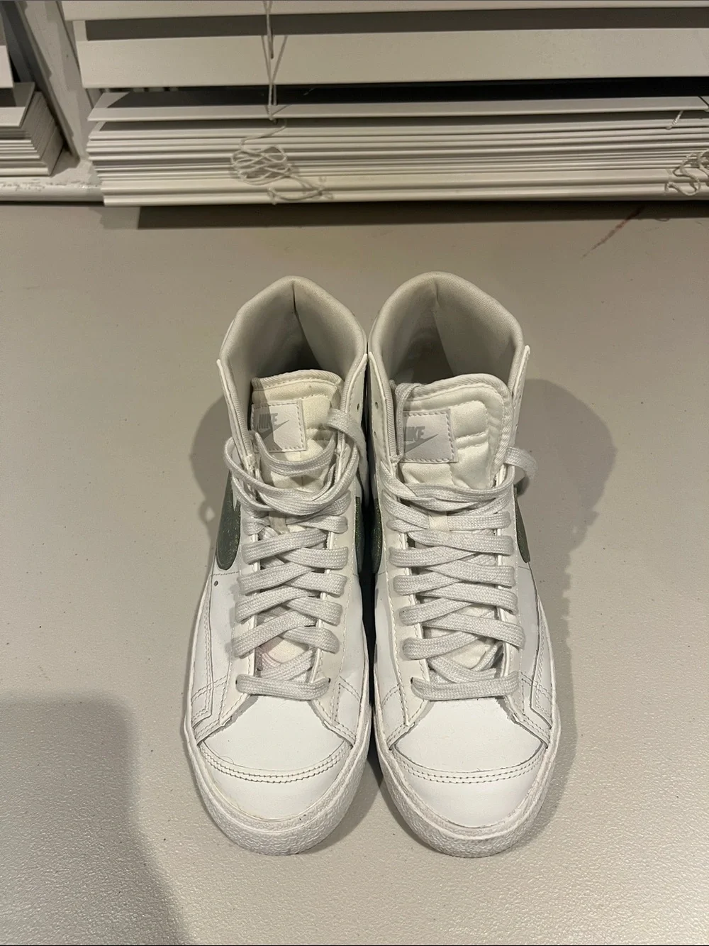 Nike White High-Top Sneakers with Green Swoosh Accent